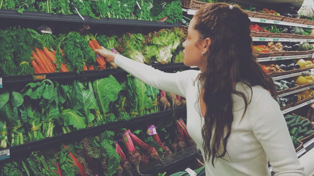 Woman shopping for groceries at the vegetable aisle